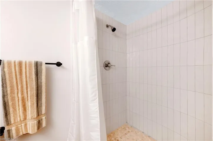 Bathroom featuring a shower with shower curtain