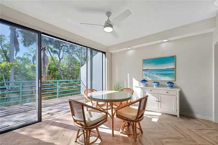 Dining space featuring ceiling fan and light parquet flooring