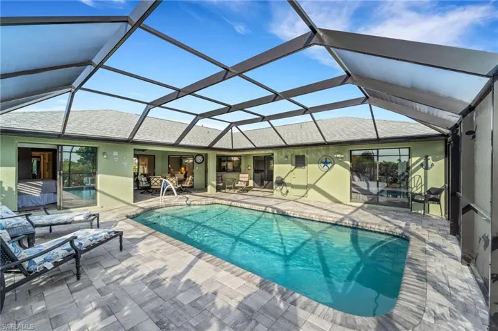 View of pool featuring a patio and a lanai