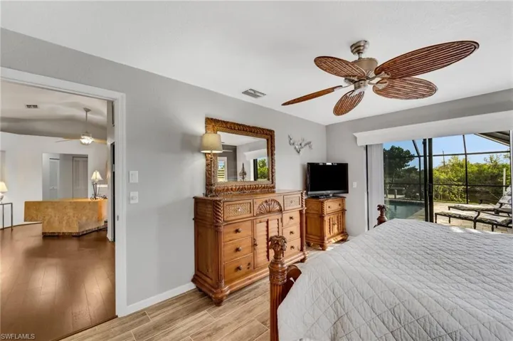 Bedroom with ceiling fan, light hardwood / wood-style floors, and access to outside