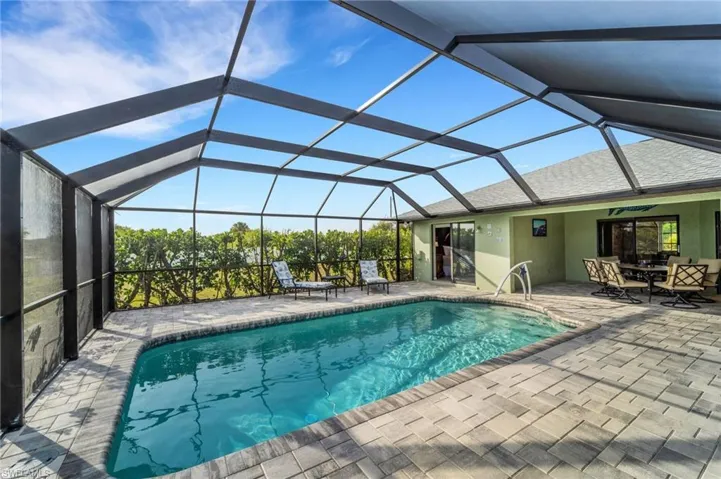View of swimming pool featuring ceiling fan, a lanai, and a patio