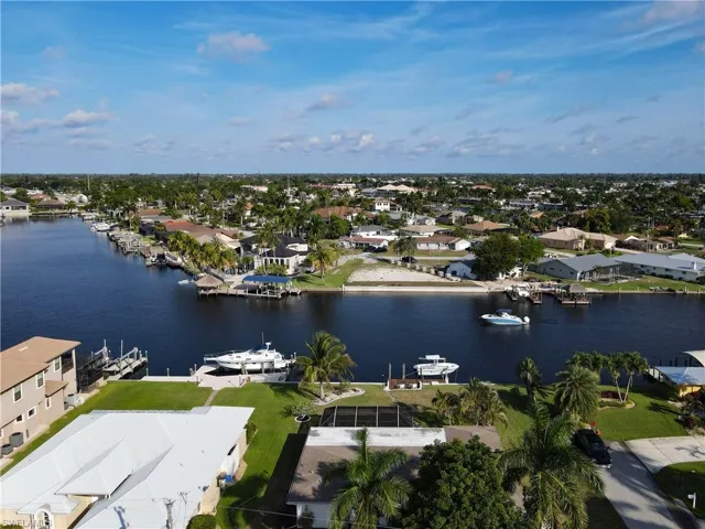 Aerial perspective of suburban area with a nearby body of water