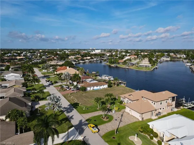 Aerial perspective of suburban area featuring a large body of water
