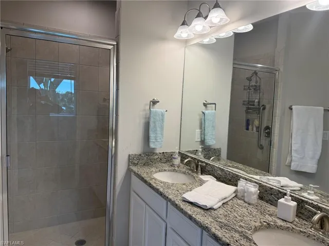 Dual vanity with undermount sinks, granite-style countertop, and brushed nickel fixtures