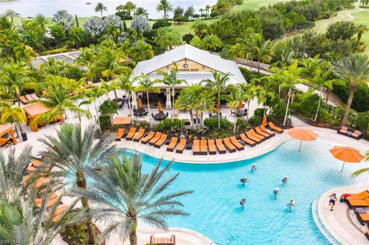 Expansive resort-style pool with integrated sun shelf and surrounding lounge area