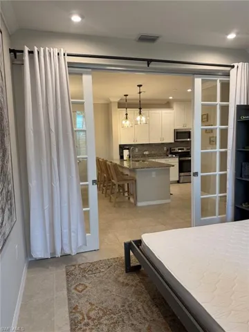 French doors with transom windows, recessed lighting, queen size murphy bed