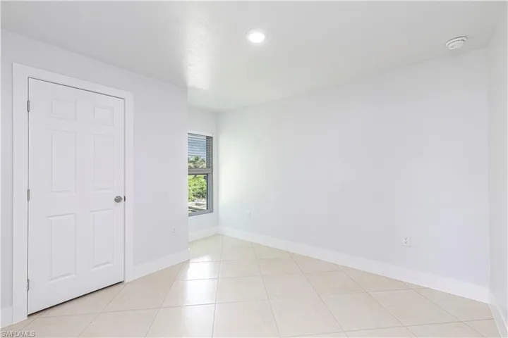 Empty room featuring light tile patterned floors
