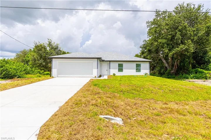 View of front of property with a front lawn and a garage