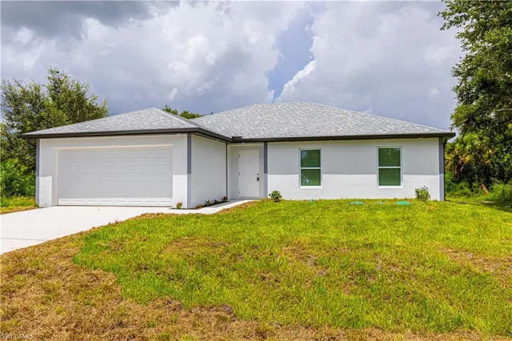 Ranch-style house with a garage and a front yard