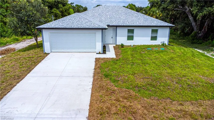 View of front of home with a front lawn and a garage