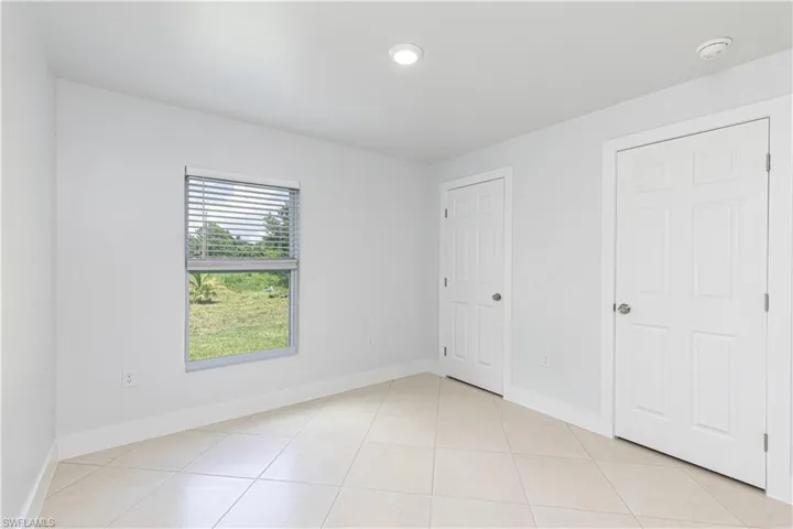 Unfurnished bedroom with light tile patterned floors
