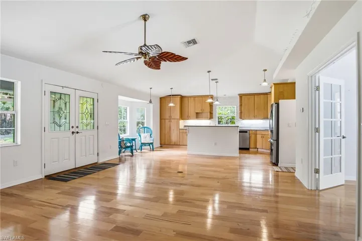 REAR HOUSE KITCHEN/LIVING AREA: Peaceful living with convenient access to Immokalee Road, Oil Well Road, and I-75, while being just minutes from the shopping, dining, and future development in one of Naples' fastest-growing areas.