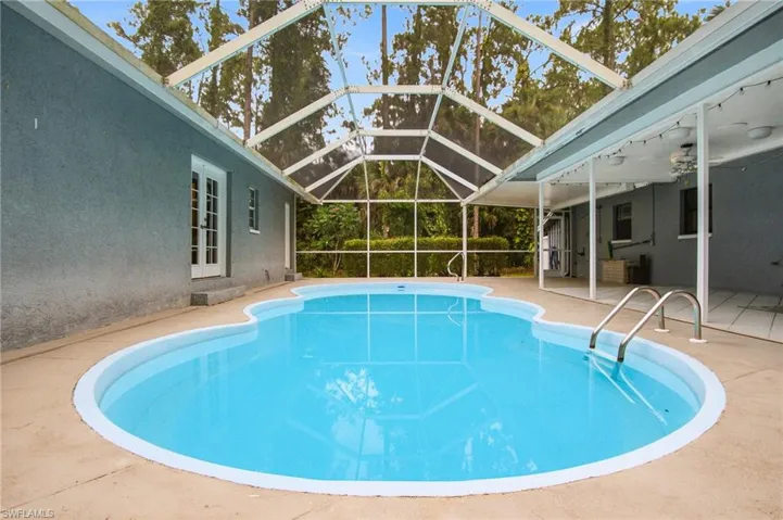 Situated between the two homes is a LARGE SCREENED POOL DECK/COURTYARD WITH A VERY LARGE IN-GROUND HEATED POOL!
