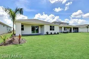 Back of home with covered lanai to the left
