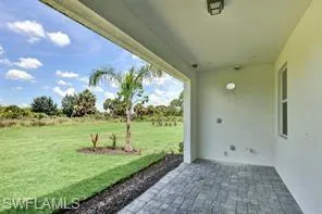 Underneath covered lanai with granite pavers, exterior privacy wall, and pre-plumbing for future outdoor kitchen