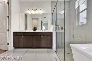 Soft-close cabinets and quartz countertops in primary bathroom