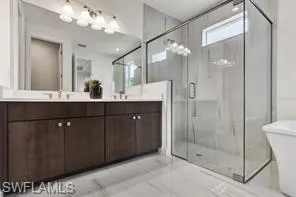 Soft-close cabinets and quartz countertops in primary bathroom