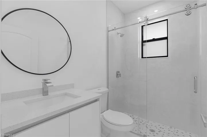 Full bath featuring vanity and a shower stall
