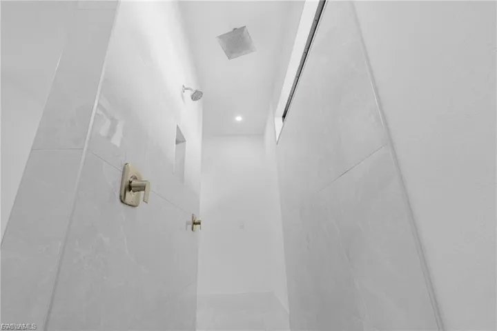 Bathroom featuring a tile shower and recessed lighting