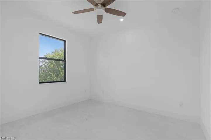 Empty room with ceiling fan and recessed lighting