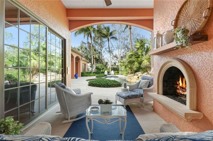 View of patio / terrace featuring ceiling fan and an outdoor fireplace