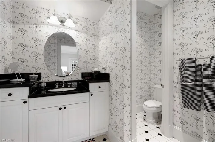Bathroom featuring vanity, tile patterned floors, and toilet