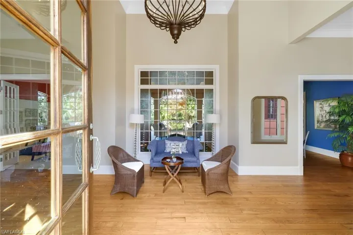 Sitting room featuring light wood-type flooring and crown molding