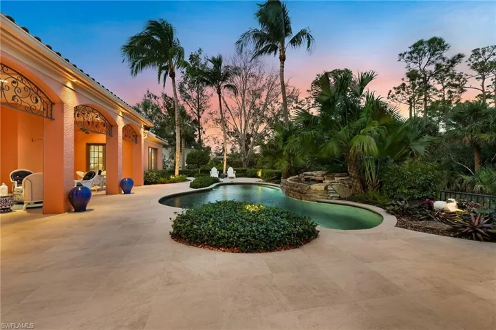 Pool at dusk with a patio area