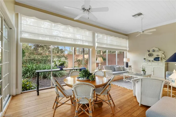 Sunroom / solarium with wood ceiling and ceiling fan