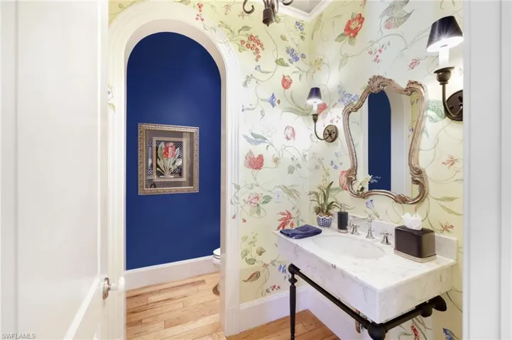 Bathroom with hardwood / wood-style floors, sink, and toilet