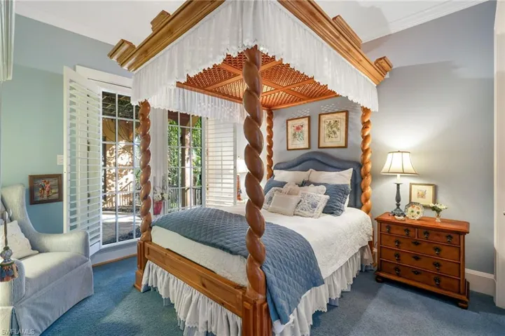 Carpeted bedroom with access to outside and crown molding