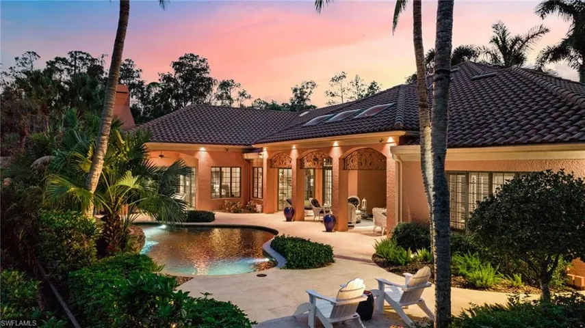 Back house at dusk with a patio area
