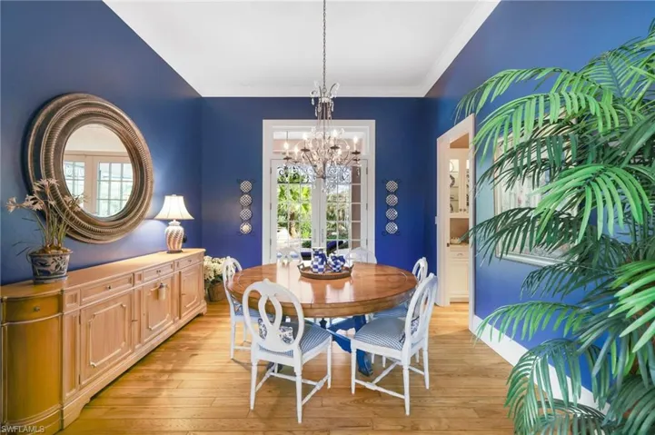 Dining room featuring ornamental molding, an inviting chandelier, and light hardwood / wood-style floors
