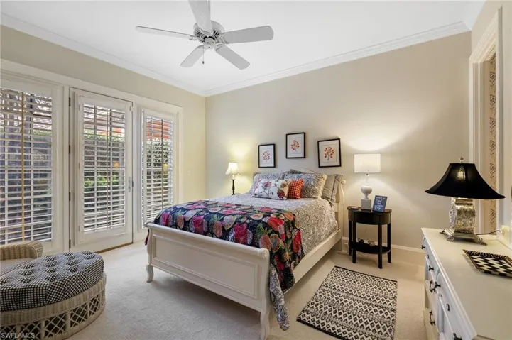 Carpeted bedroom featuring ornamental molding, access to outside, and ceiling fan