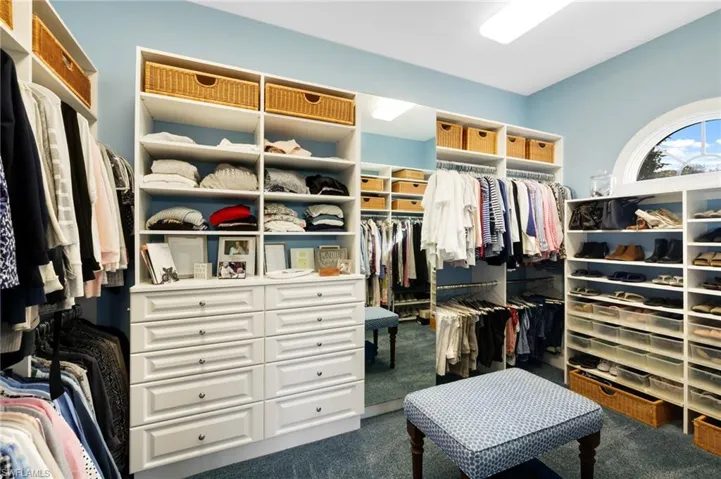Walk in closet featuring dark carpet