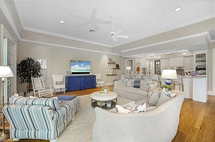 Living room with wooden ceiling, ceiling fan, light hardwood / wood-style flooring, and crown molding