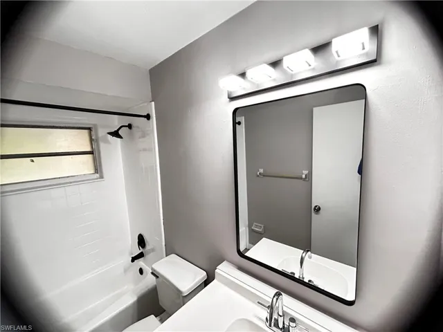 Bathroom featuring shower / tub combination and vanity