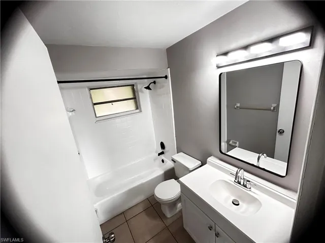 Full bathroom featuring vanity,  shower combination, and tile patterned floors
