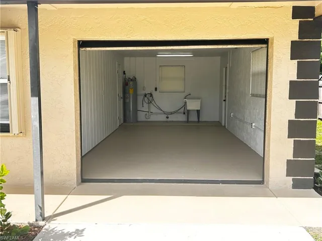 Garage featuring electric water heater