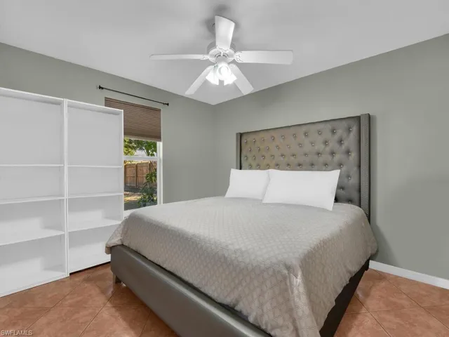 Bedroom with light tile patterned flooring and ceiling fan
