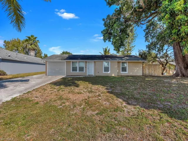 Ranch-style house with concrete driveway, stucco siding, and a garage
