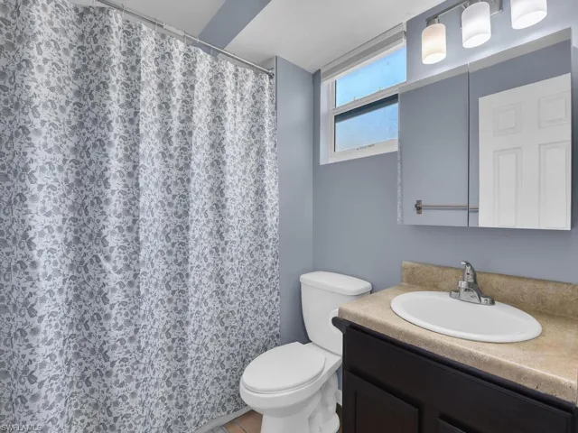 Bathroom featuring vanity and a shower with shower curtain