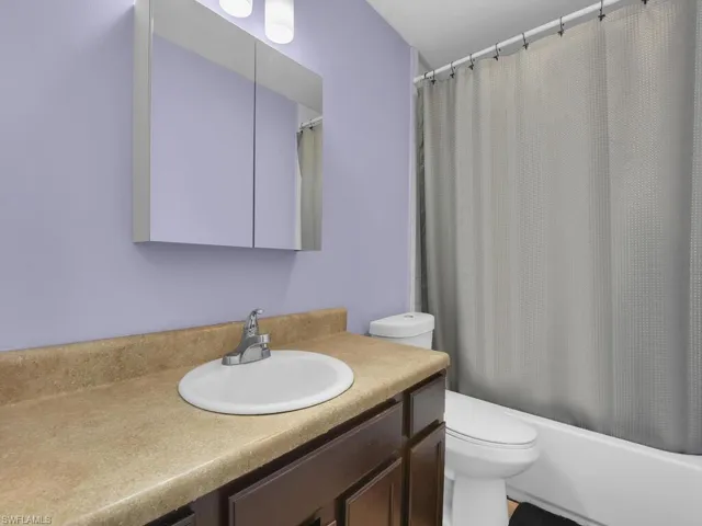 Bathroom with vanity and shower / bathtub combination with curtain