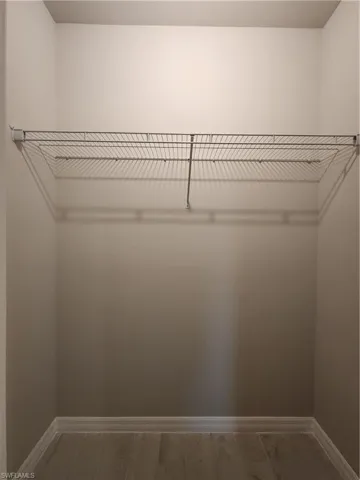 Walk in closet featuring light wood-style floors