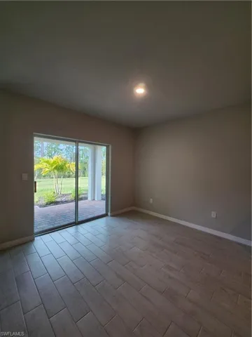 Unfurnished room featuring wood tiled floors and recessed lighting