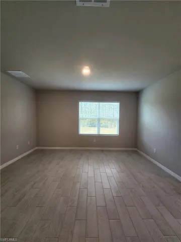 Unfurnished room with baseboards and light wood finished floors