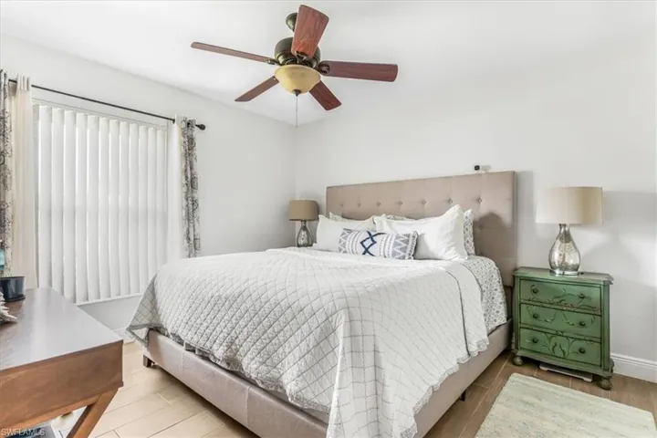 Bedroom with wood finished floors and a ceiling fan