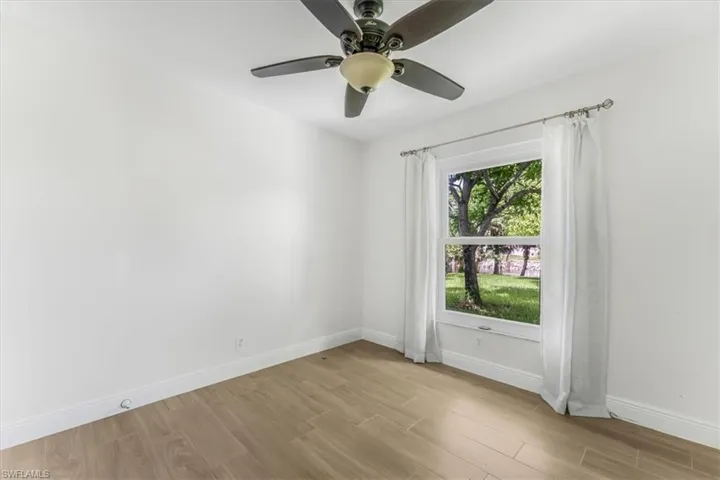Unfurnished room with light wood finished floors and ceiling fan