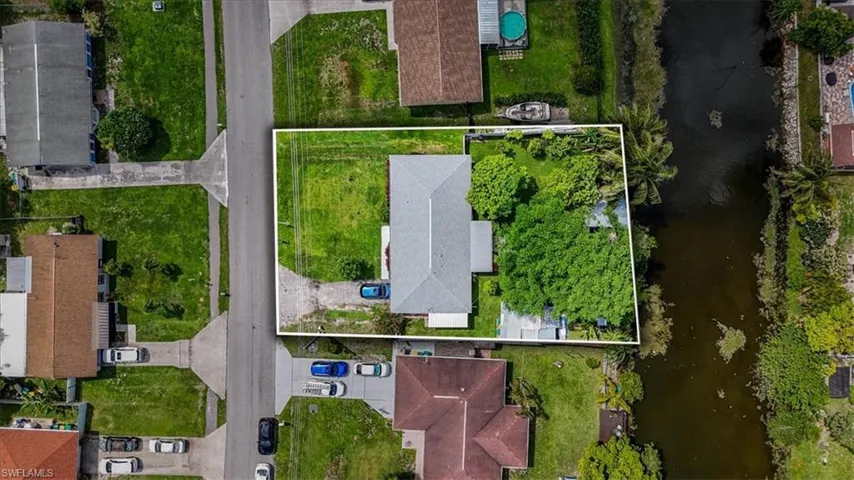 Aerial view of property's location featuring property parcel outlined and a nearby body of water