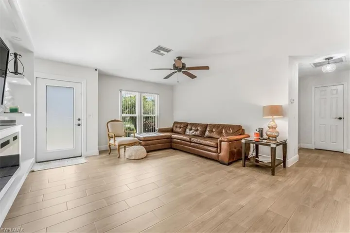 Living room with a ceiling fan and light wood-style floors